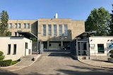 An embassy building with gates and a security post in Pyongyang, North Korea.