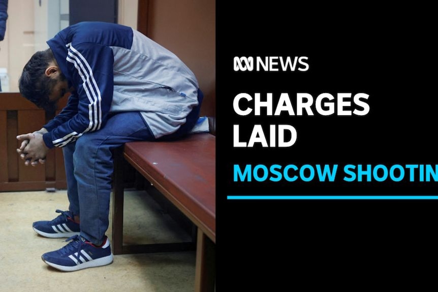 Charges Laid, Moscow Shooting, Man in tracksuit sits with his head bowed and hands clasped.