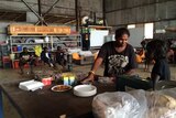 Evacuated Daly River residents have lunch as they wait at Darwin showgrounds