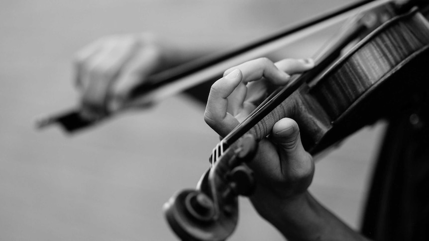 Black and white image of someone playing the violin