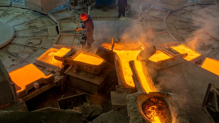 A man works in a copper smelting factory