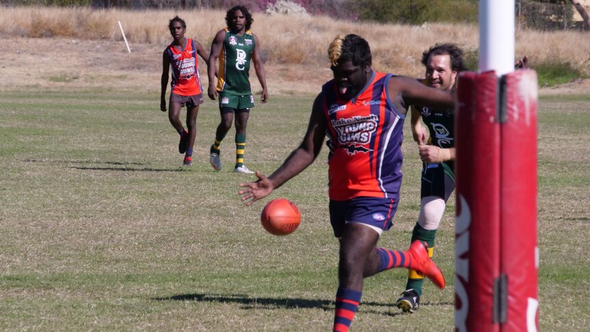 A Young Guns player kicks towards goal