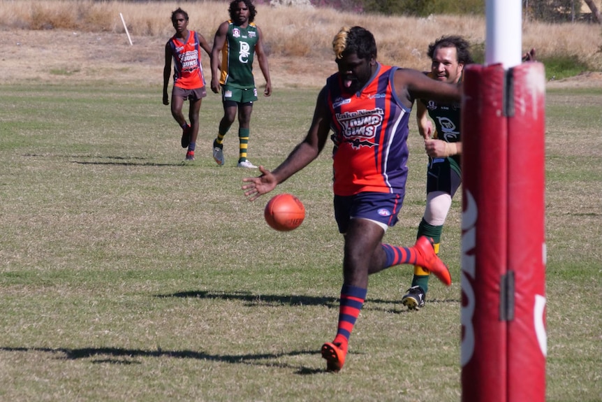 A Young Guns player kicks towards goal