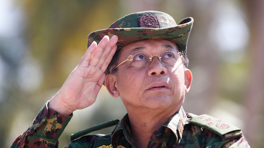Senior General Min Aung Hlaing salutes, wearing full military gear