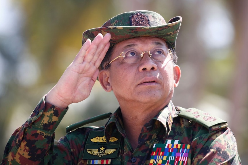 Senior General Min Aung Hlaing salutes, wearing full military gear