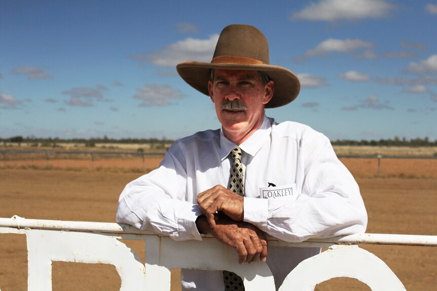 Sam Brown stands in front of the gate at Koorooinya