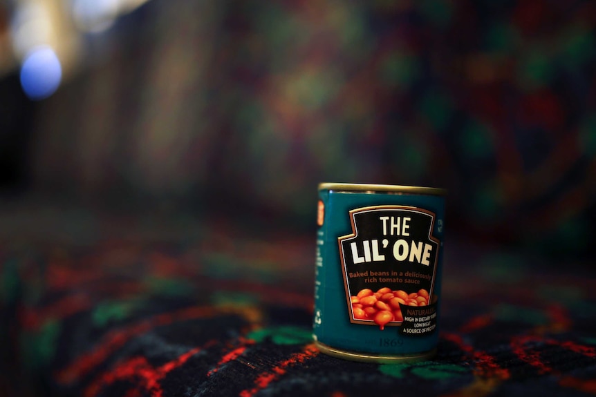 A can of baked beans on the seat of a Perth train.
