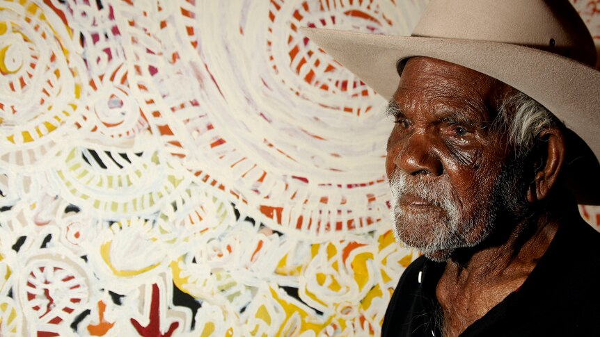 Dickie Minyintiri, 2011 winner of the National Telstra Art Award, poses with his painting Kanyalakutjina (Euro tracks).
