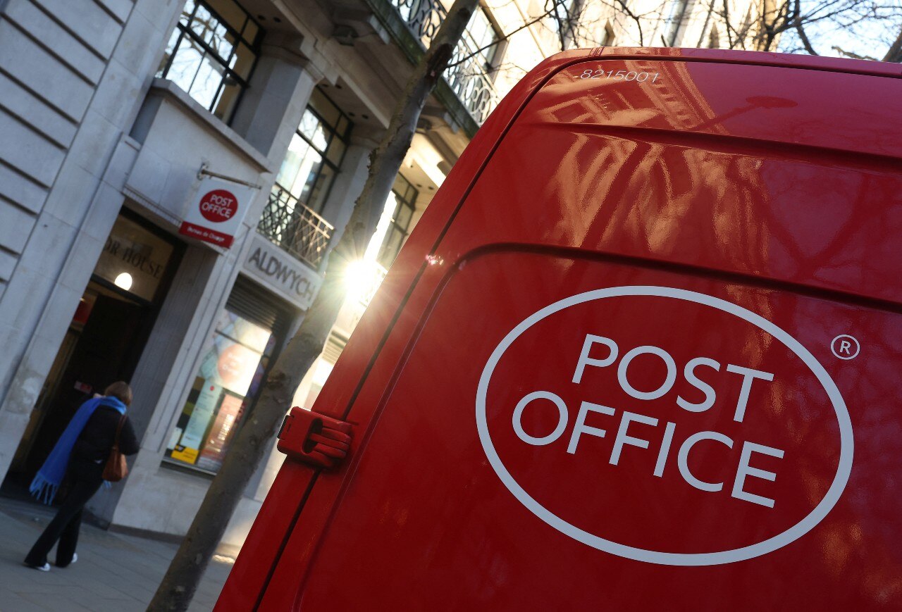 The back of a van, with a decal on it that reads Post Office
