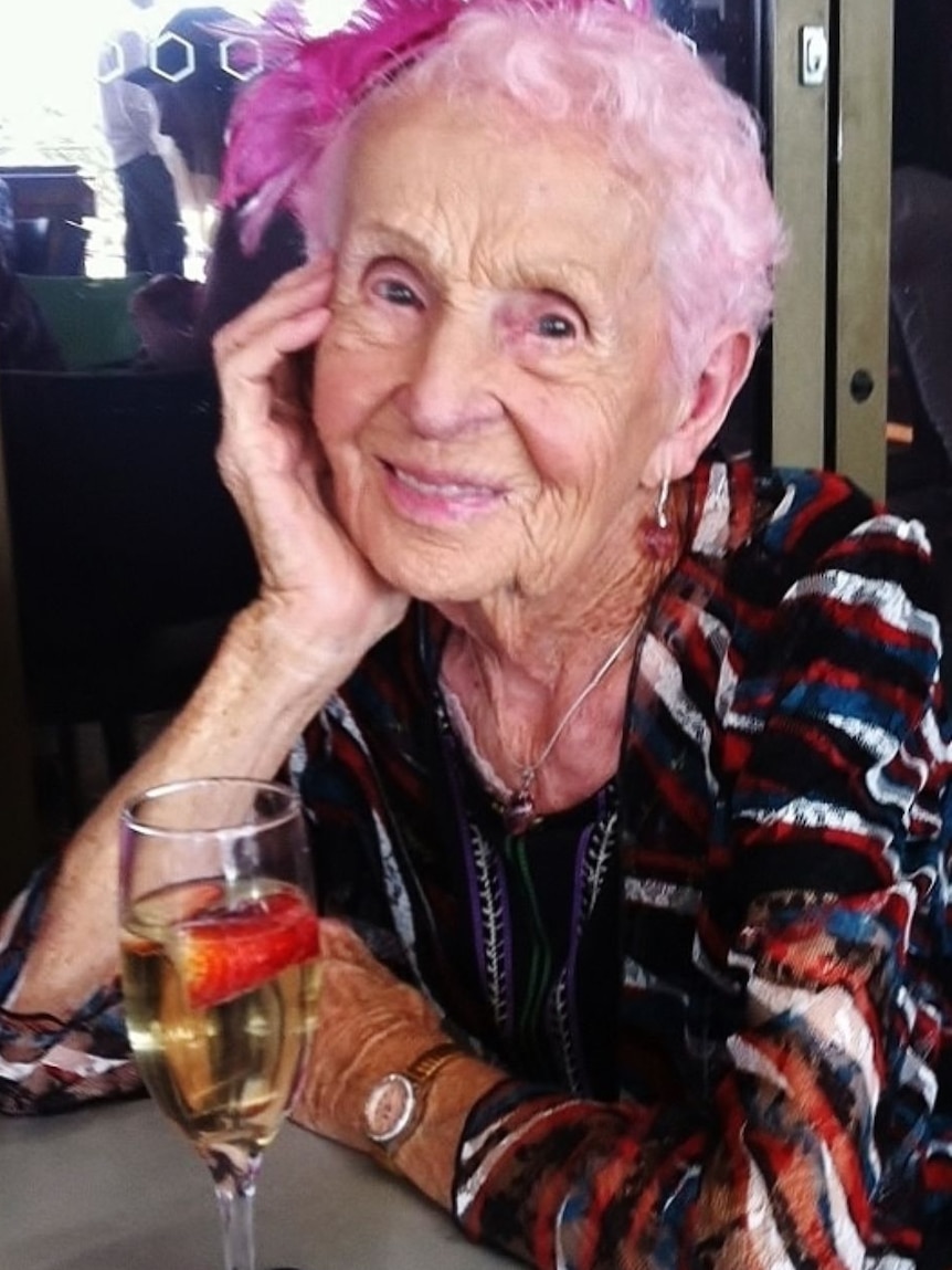 Smiling older lady with pink hair