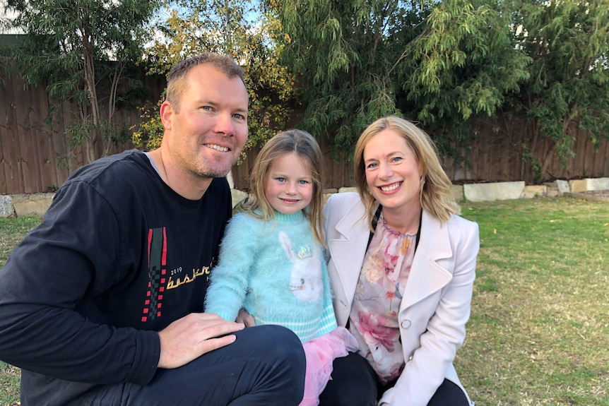 A dad and mum couple with a young girl