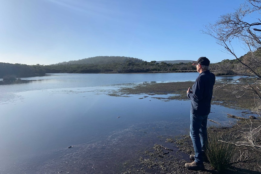 Man looking across a dam