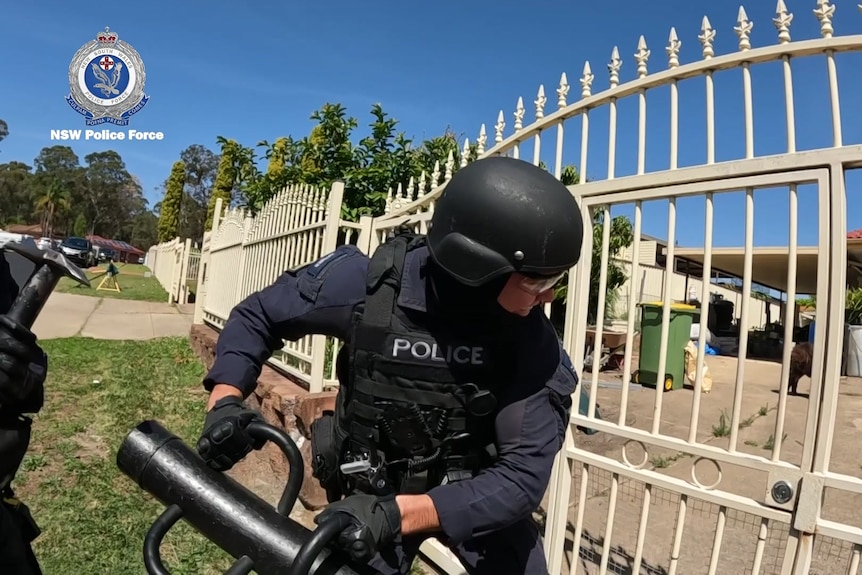 police use battering ram to hit gate