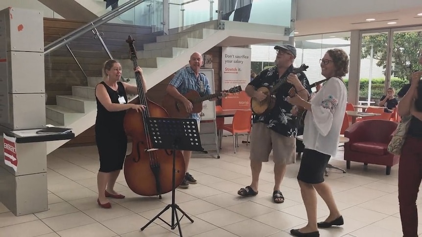 Musicians playing in the foyer of a hospital.