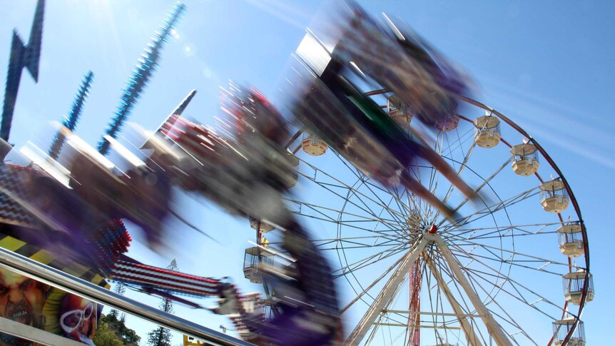 A ride in sideshow alley whizzes around at the Ekka in Brisbane