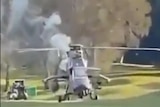 An ADF Eurocopter Tiger smoking on a Gold Coast golf course.