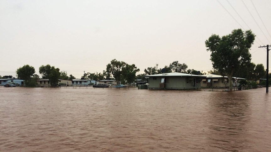 Floodwaters surround houses and roads in the town of Dajarra