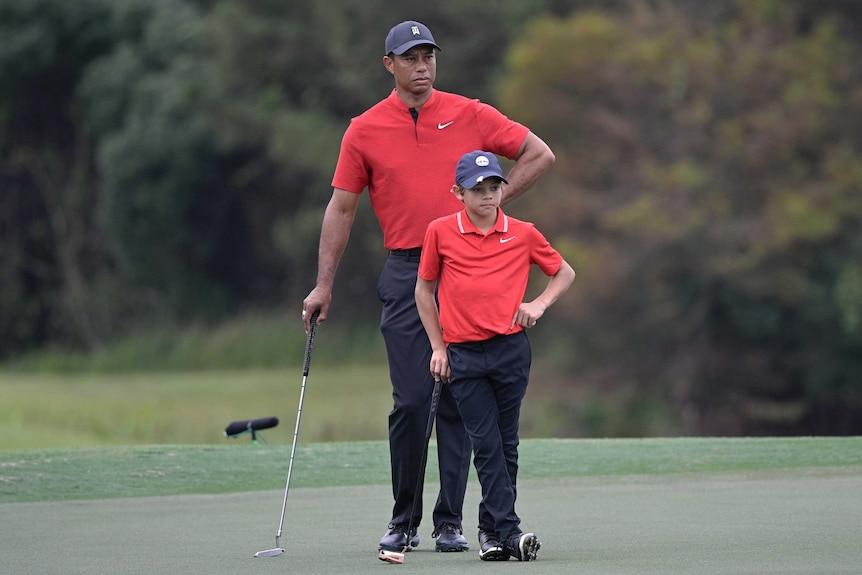 Tiger Woods and son Charlie lean on their clubs