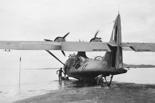 A black and white image of an aircraft resting on water