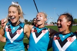 Amelie Borg sings the Port Adelaide theme song alongside Erin Phillips and Justine Mules