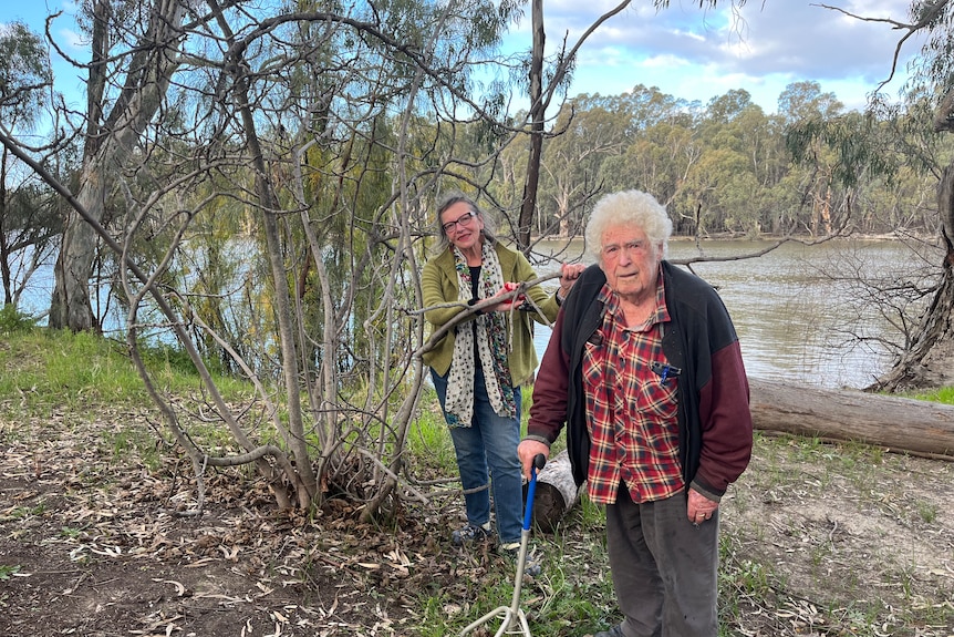 Yasmin Sadler and Mick Harding stand next to a dormant fig tree on the banks of the Murray River at Euston
