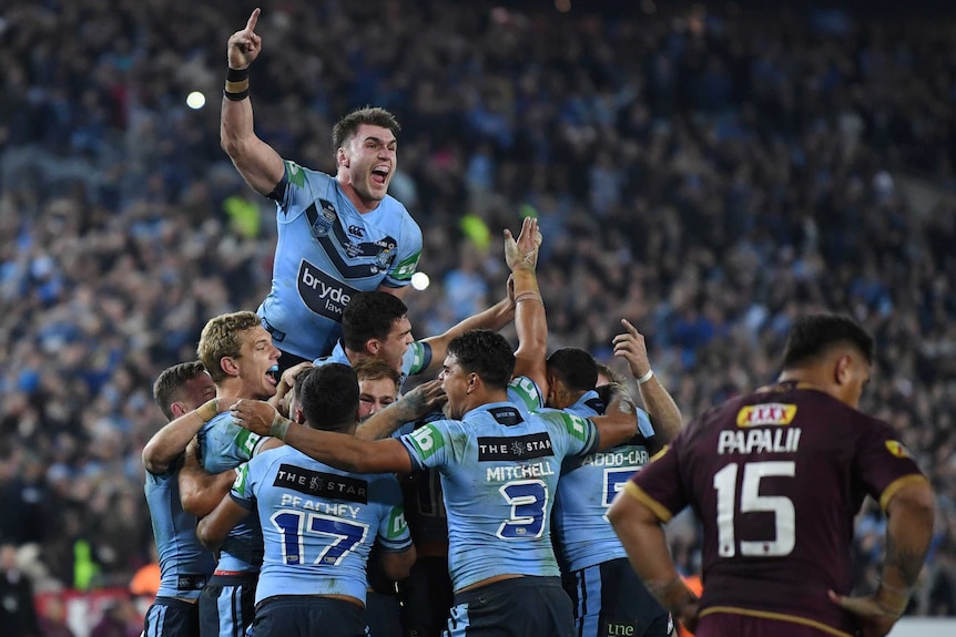Blues players celebrate their State of Origin win