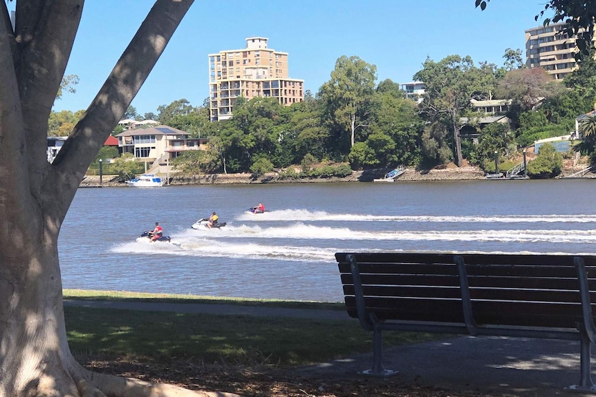 Three jet skiers on the Brisbane River at West End.
