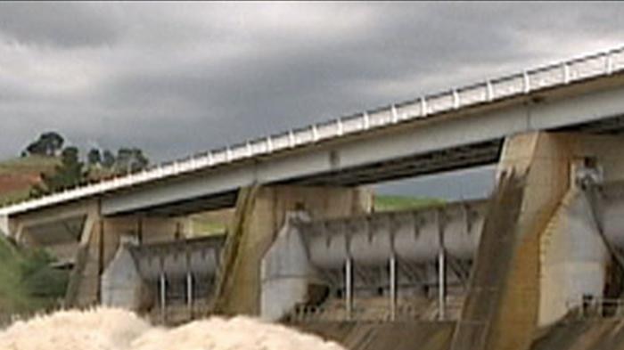 Summer floods: the gates open on Canberra's Scrivener Dam in December.