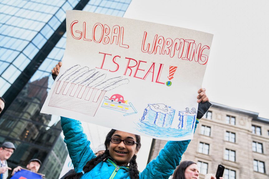 A young girl holds up her sign at the Stand up for Science rally in Boston's Copley Square