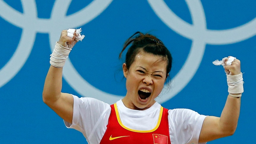 Mingjuan Wang celebrates her lift on the women 48Kg Group A weightlifting.