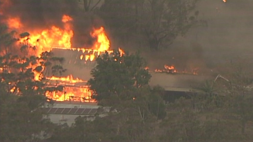 A building can be seen from above, engulfed in flames