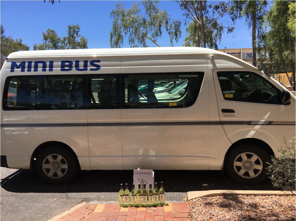 Eight bottles of chardonnay placed next to a minibus