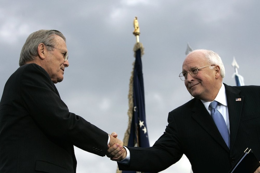 Defence Secretary Donald H. Rumsfeld (left) shakes hands with Vice President Dick Cheney.