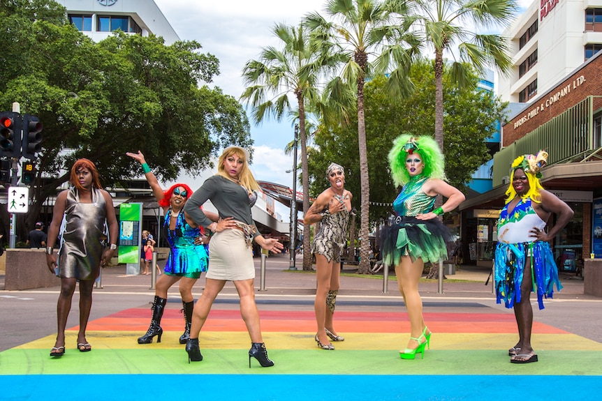 Colour photograph of six contestants from Miss First Nations drag pageant posing at a rainbow crossing in Darwin.