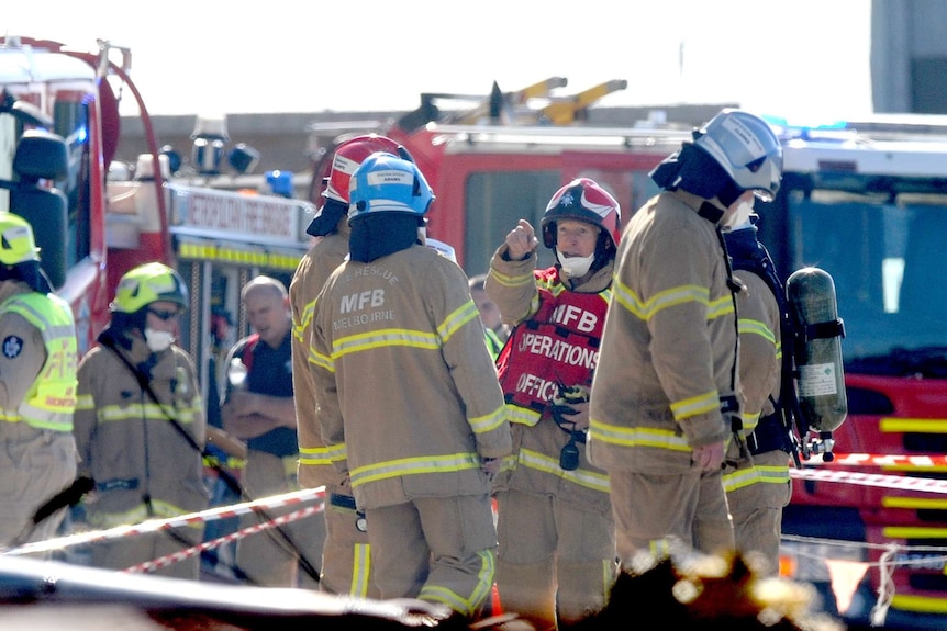 Fire crew at the scene of a plane crash near Essendon airport