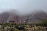 A low cloud hanging over Uluru in June 2023