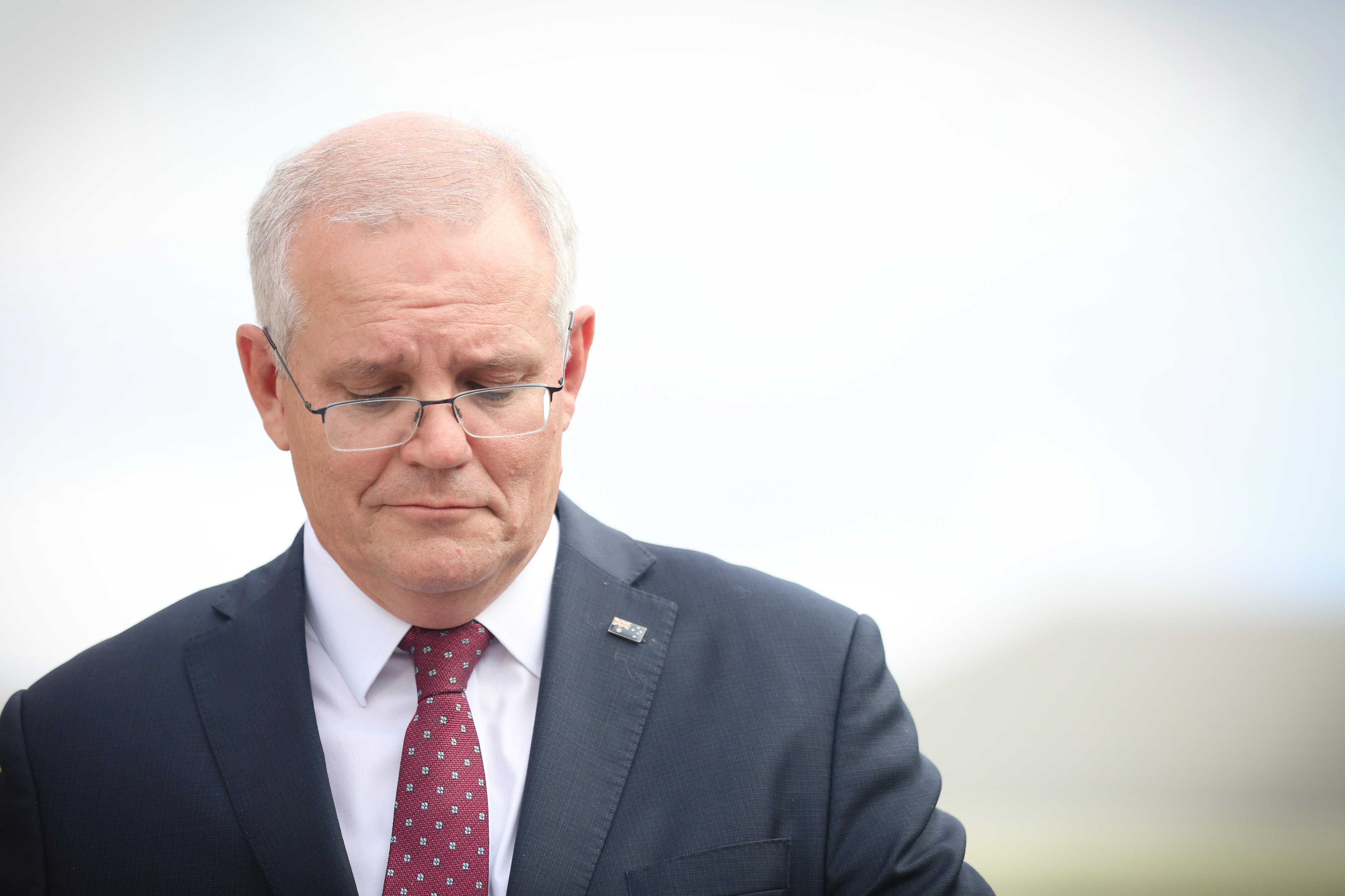 Scott Morrison looks down while out campaigning 