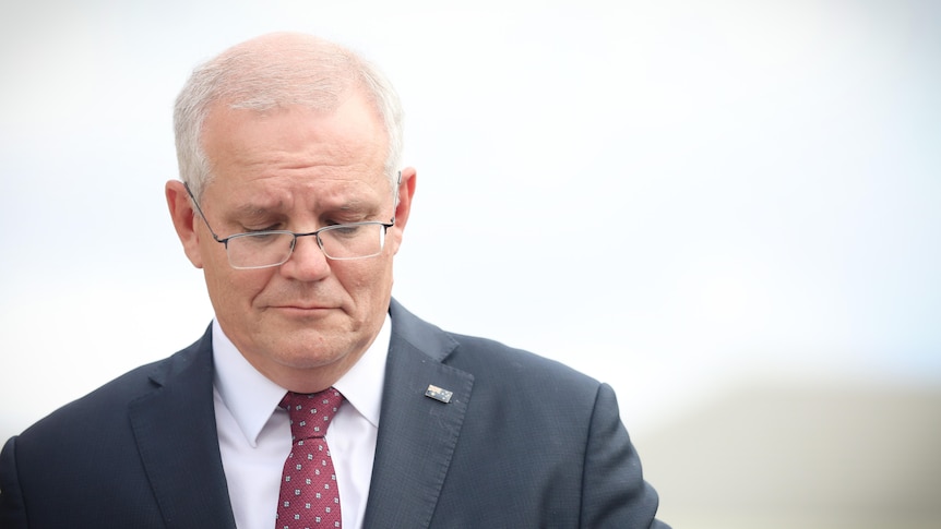 Scott Morrison looks down while out campaigning 