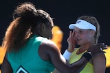 Serena Williams consoles Dayana Yastremska at the net at the Australian Open.