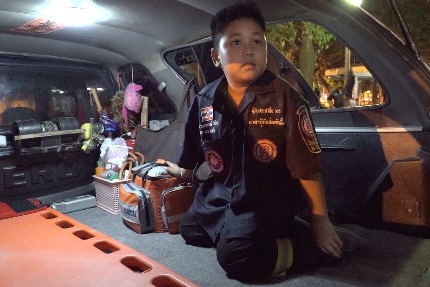 Atsadayut Kumkatog joins his dad for night duty with the Poh Teck Tung charity in Bangkok.