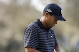 Tiger Woods texts on his mobile phone