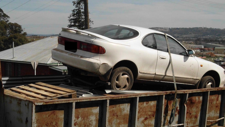 Toyota Celica in skip bin at Kelso