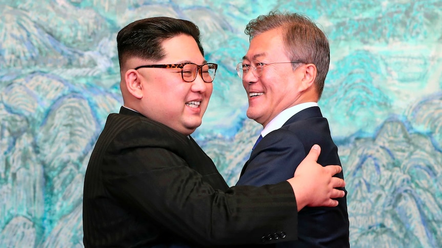 Kim Jong-un and South Korean President Moon Jae-in embrace after signing their joint statement