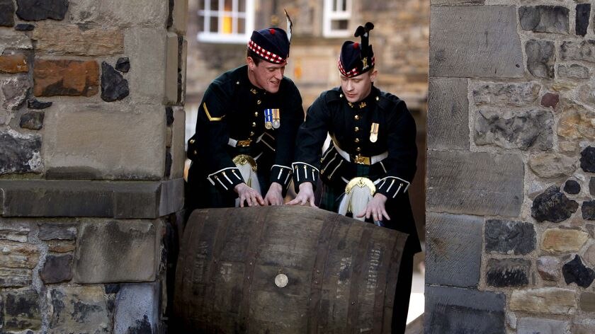 Soldiers push a wooden cask of Mortlach 70-year-old single malt whisky at Edinburgh Castle