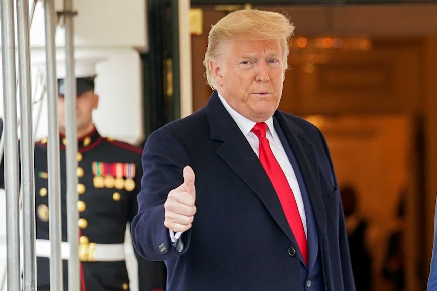 Donald Trump giving the thumbs up outside the White House