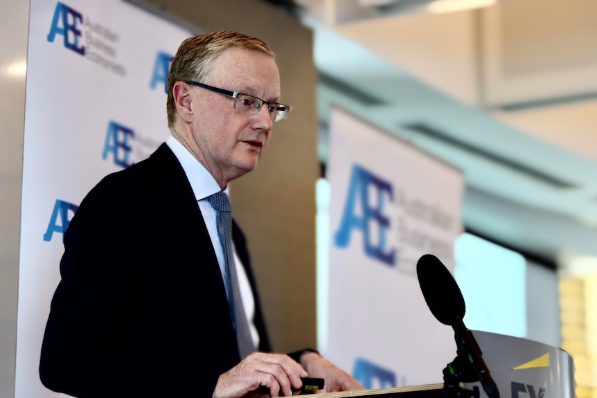 Reserve Bank governor Philip Lowe speaks at a podium at an Australian Business Economists event.