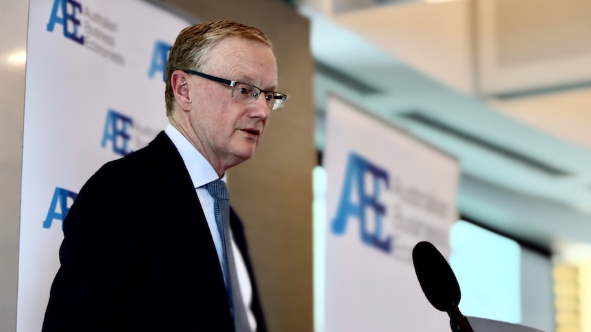 Reserve Bank governor Philip Lowe speaks at a podium at an Australian Business Economists event.