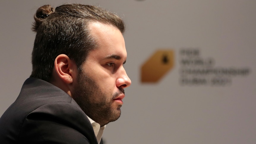 A profile picture of a pensive-looking chess player during a game in the world championship.