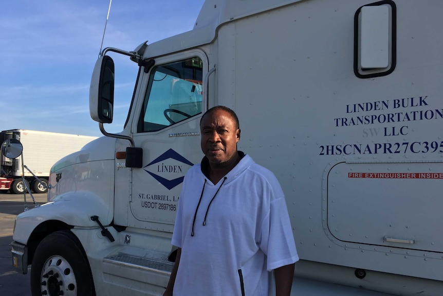 Wayne Johns stands beside his truck.