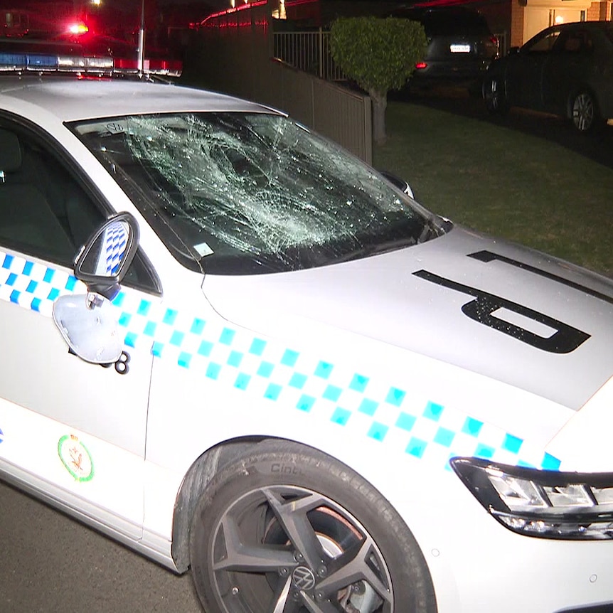 a damaged police car after an alleged stabbing incident at wakeley